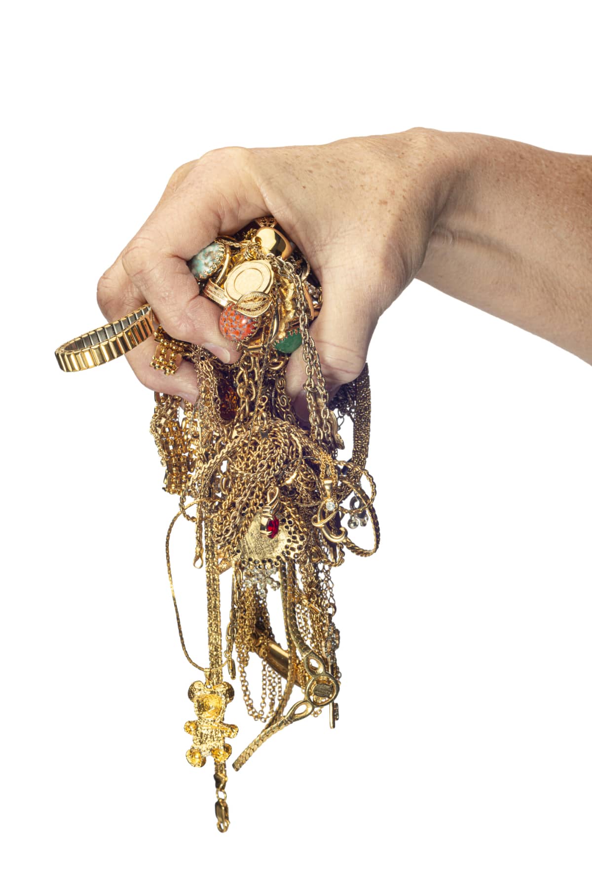 Vertical shot of a woman's hand holding tangled necklaces and bracelets