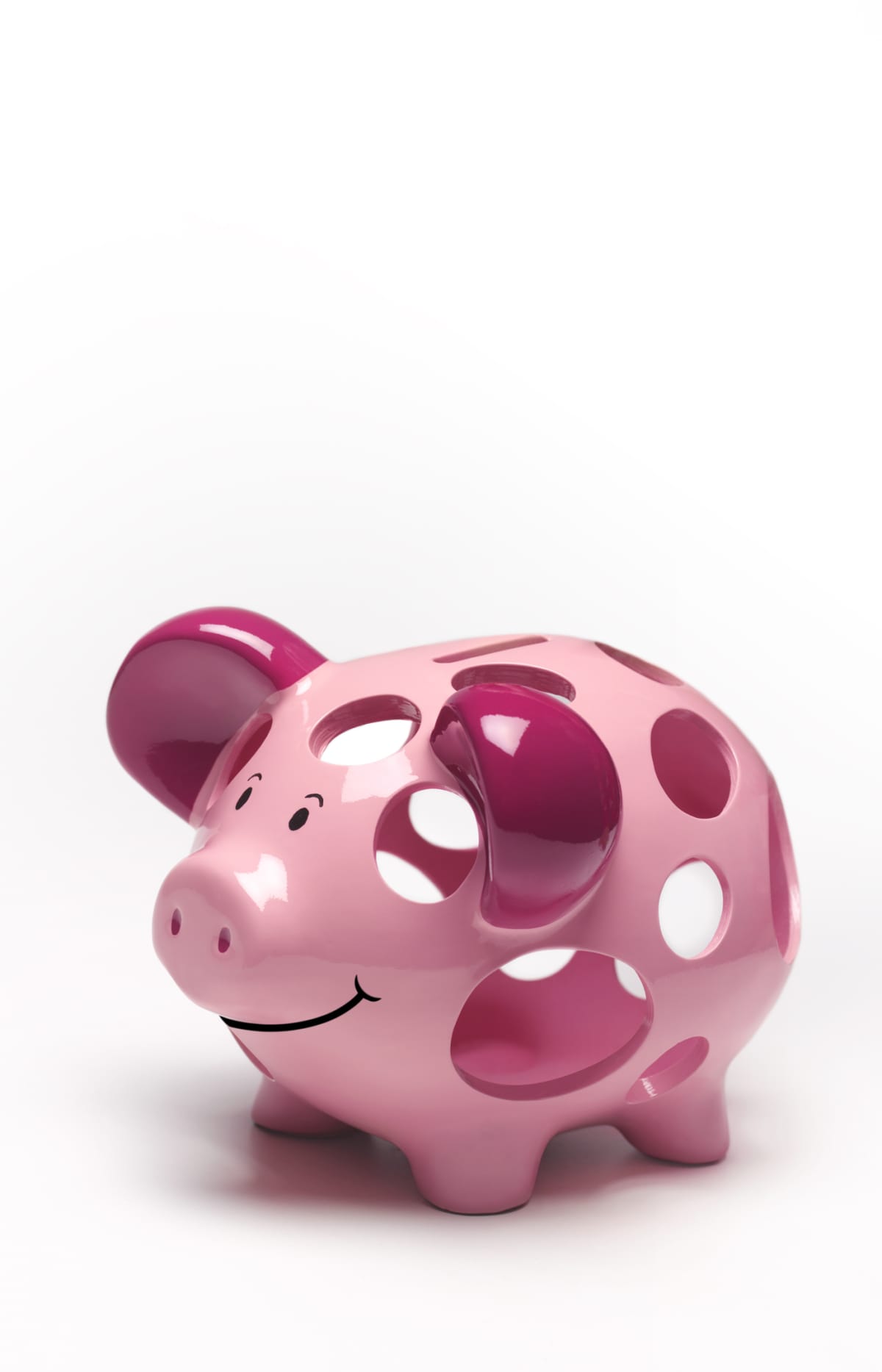 A pink piggy bank with large holes in it on a white background