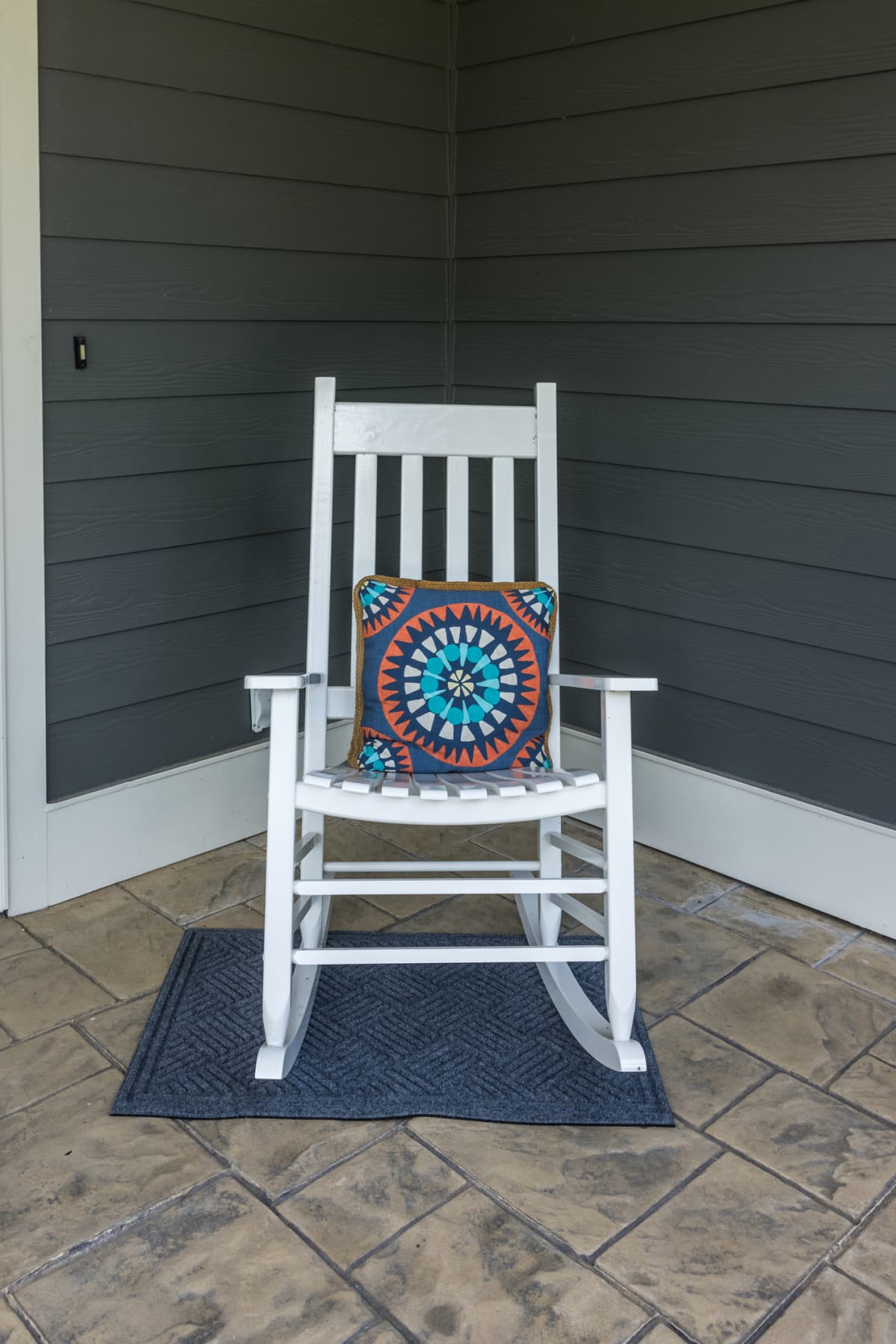 Rocking chair sitting on stamped concrete patio