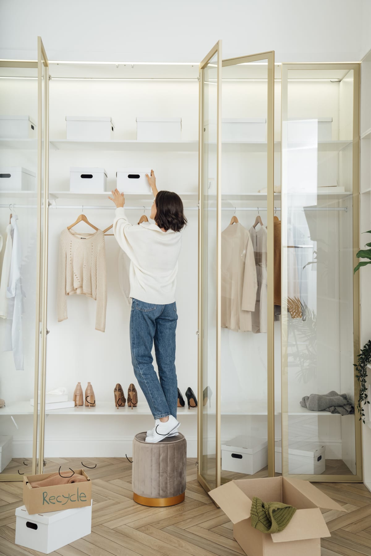 A woman organizes a white closet
