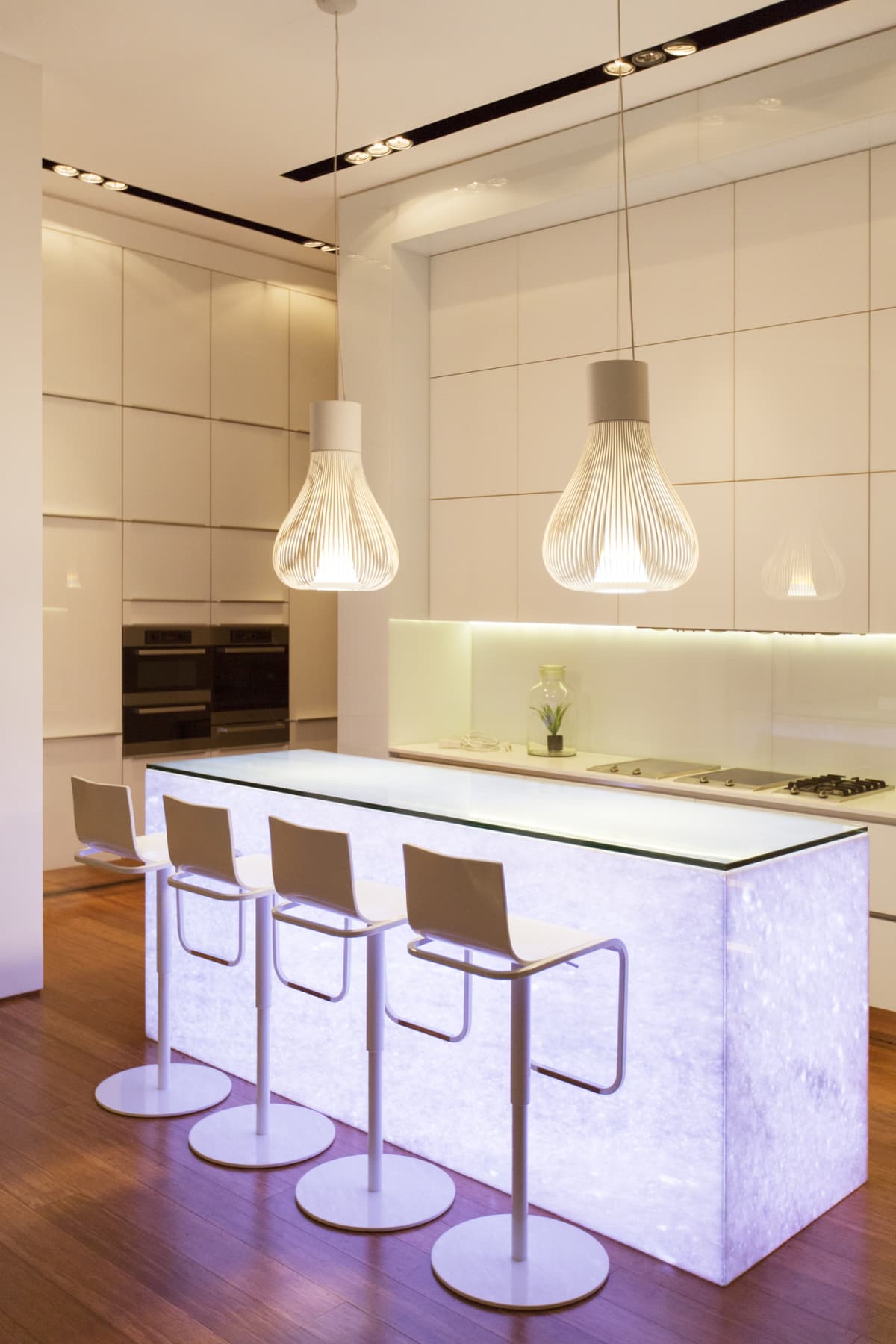 Modern kitchen design with central island of white composite Corian