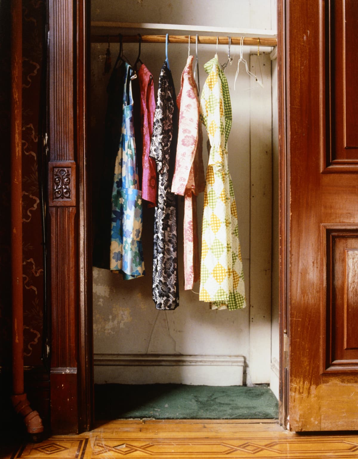 Women's clothes hanging in an old-fashioned wooden closet