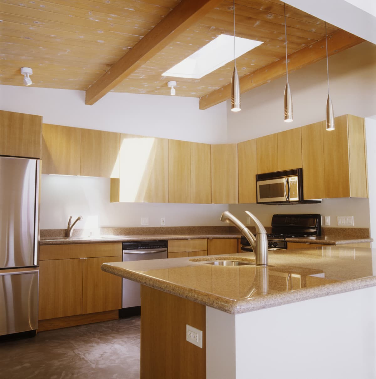 Minimalist kitchen with blond wood cabinets