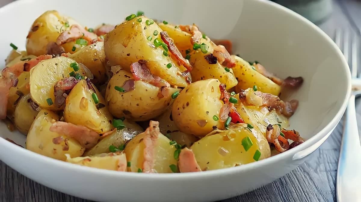 dish of potato salad with bacon and herbs