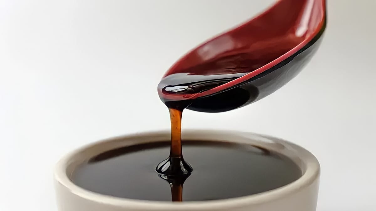 teriyaki sauce pouring from spoon into dish of sauce