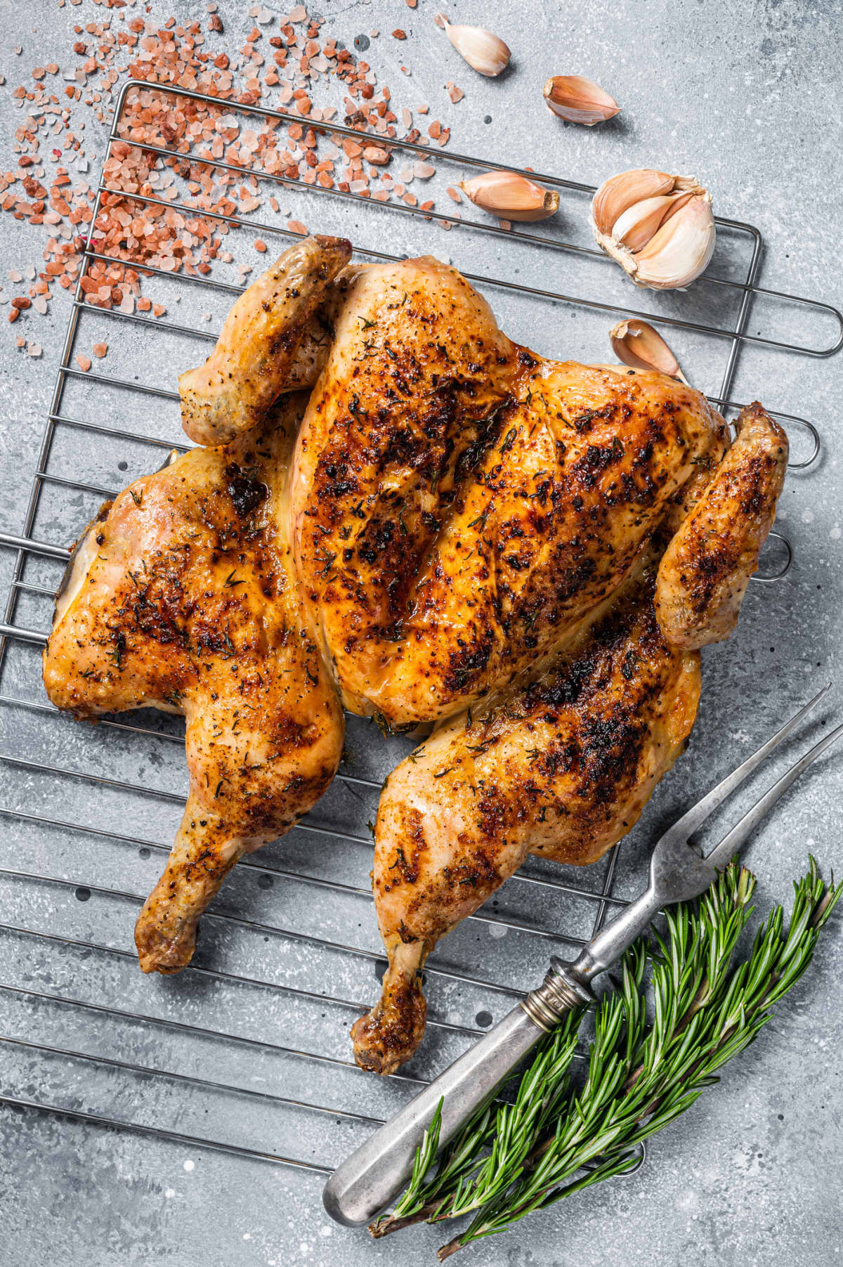 A spatchcocked chicken on the grill