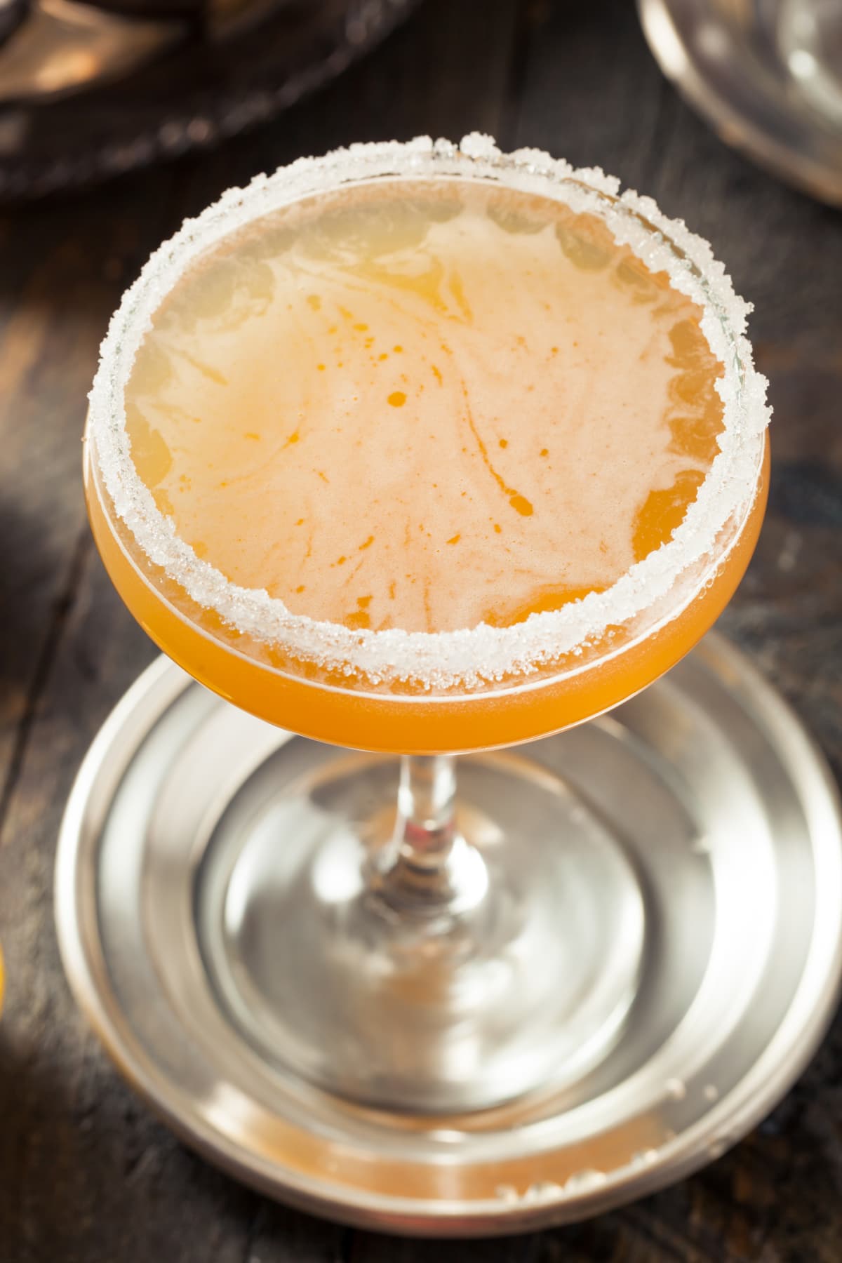 A citrus cocktail with a thick sugar rim