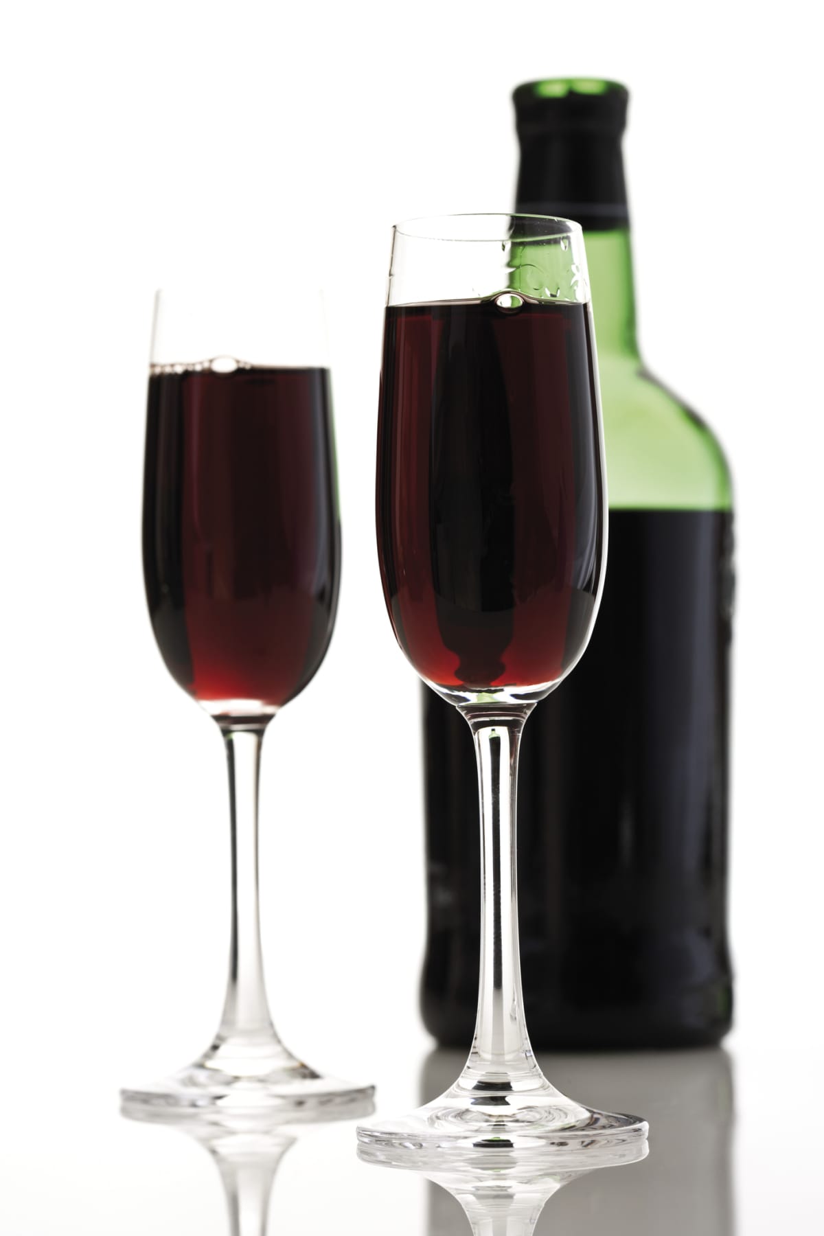 Port wines in two glasses and a bottle in the background