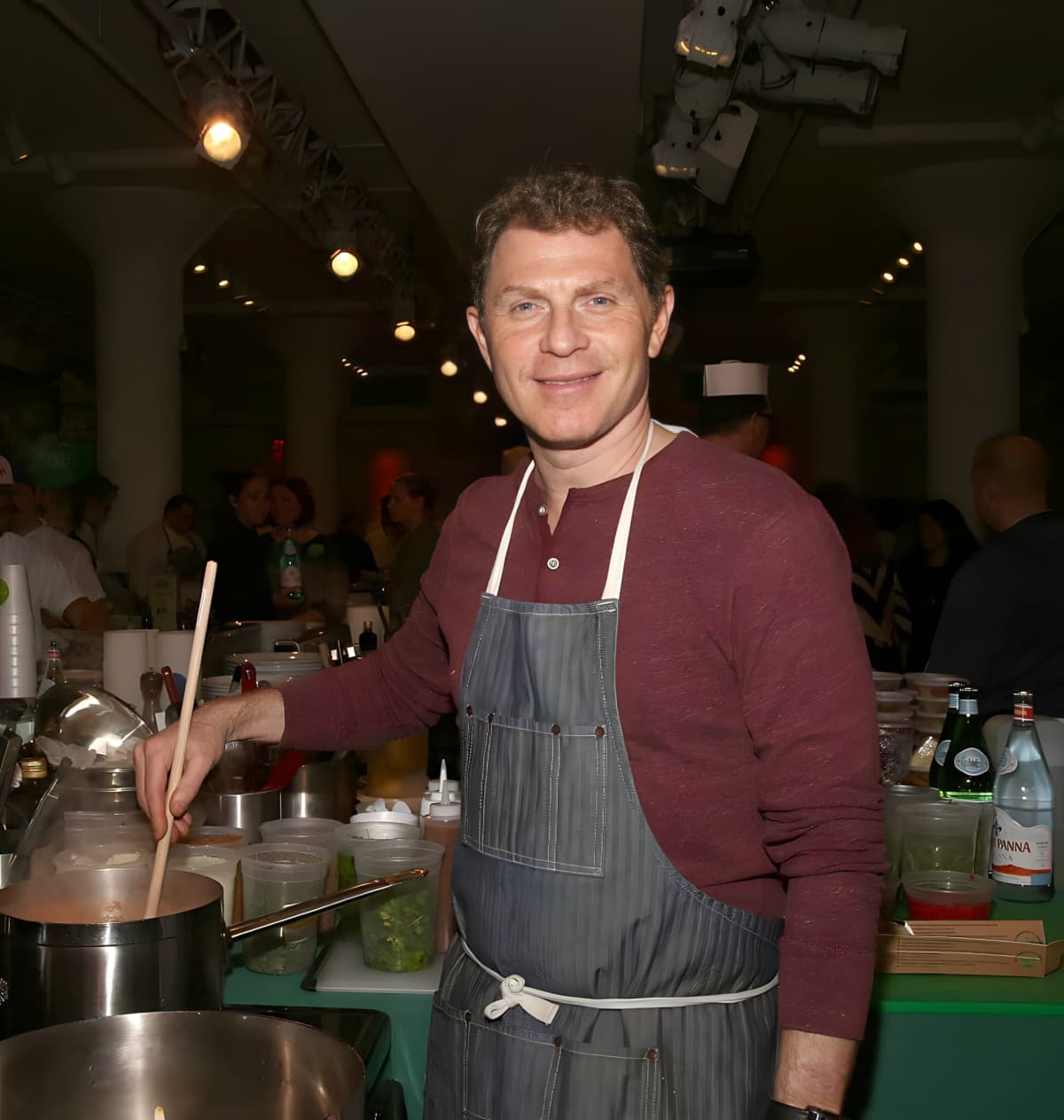 Chef Bobby Flay cooking in a restaurant kitchen