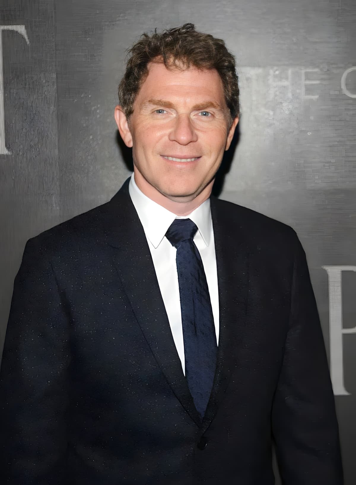 Chef Bobby Flay in a black suit