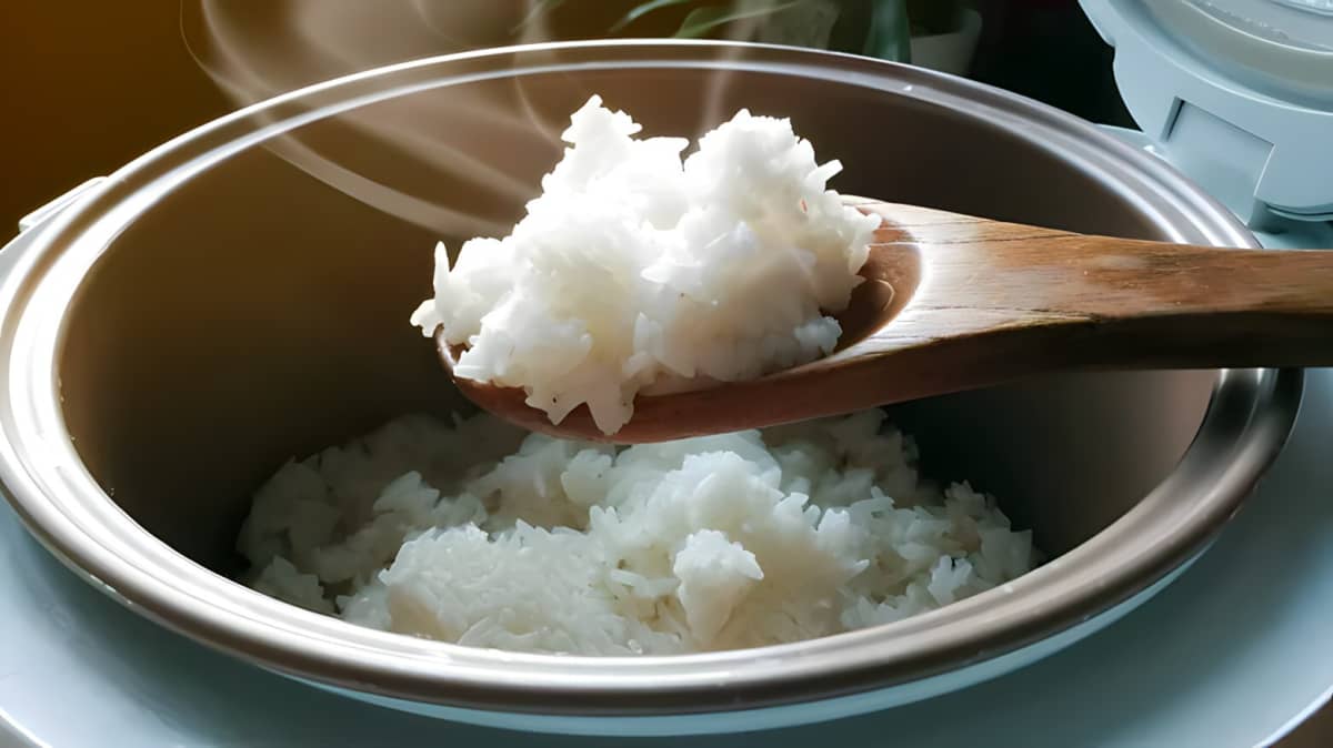 White rice being scooped from a pot