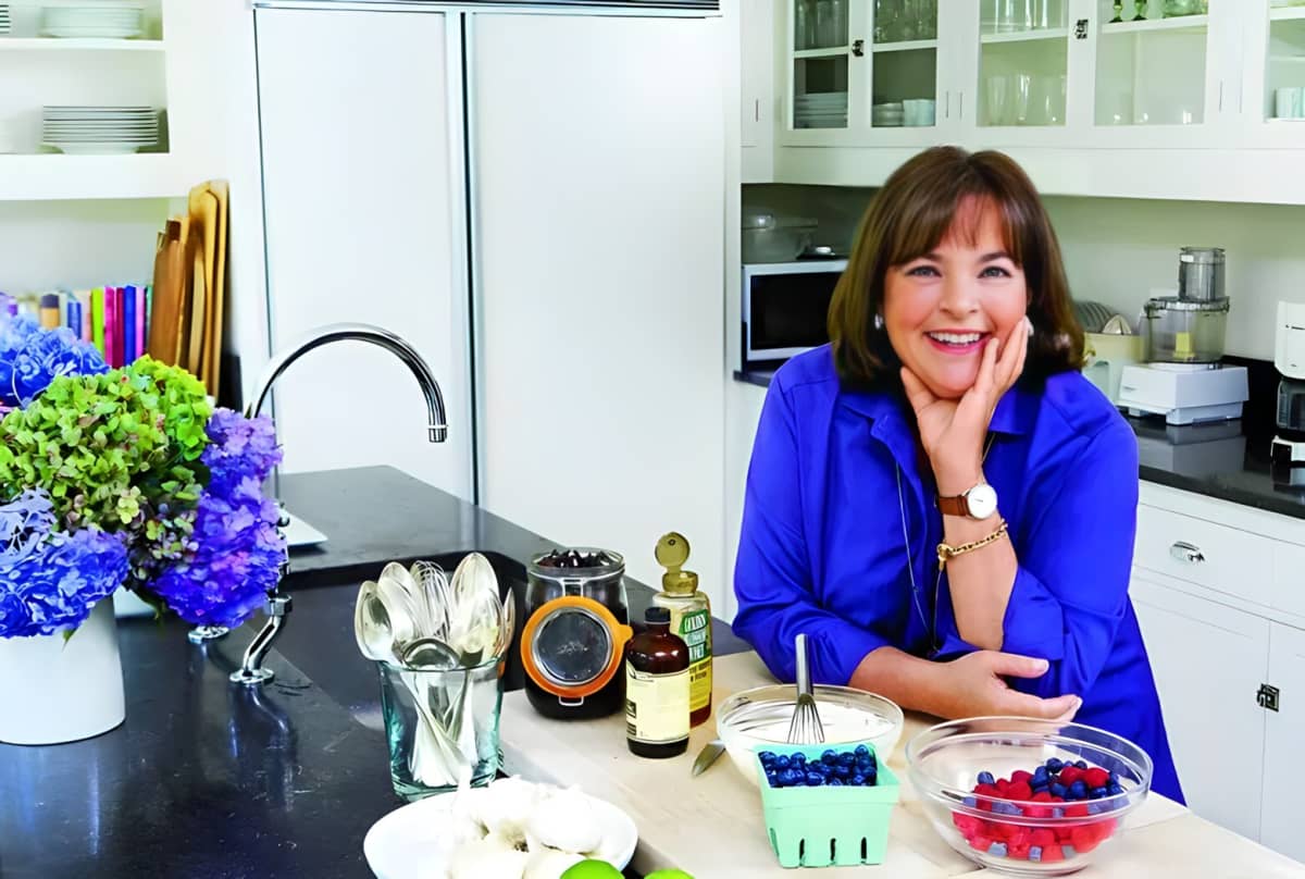 Ina Garten wearing blue, smiling in her kitchen