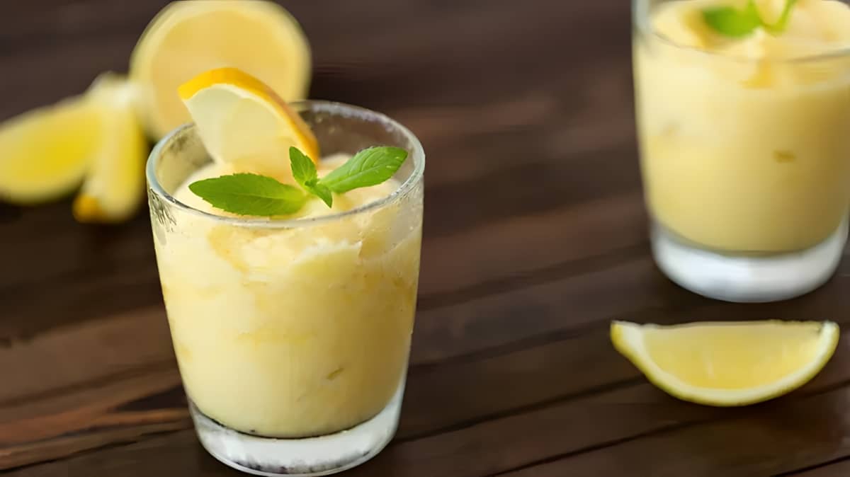 A glass of whipped lemonade with a mint and lemon garnish