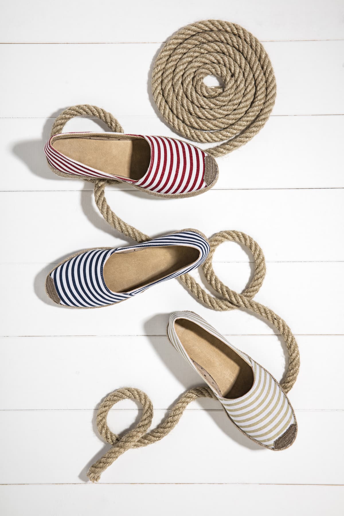 Striped espadrille shoes on a white background