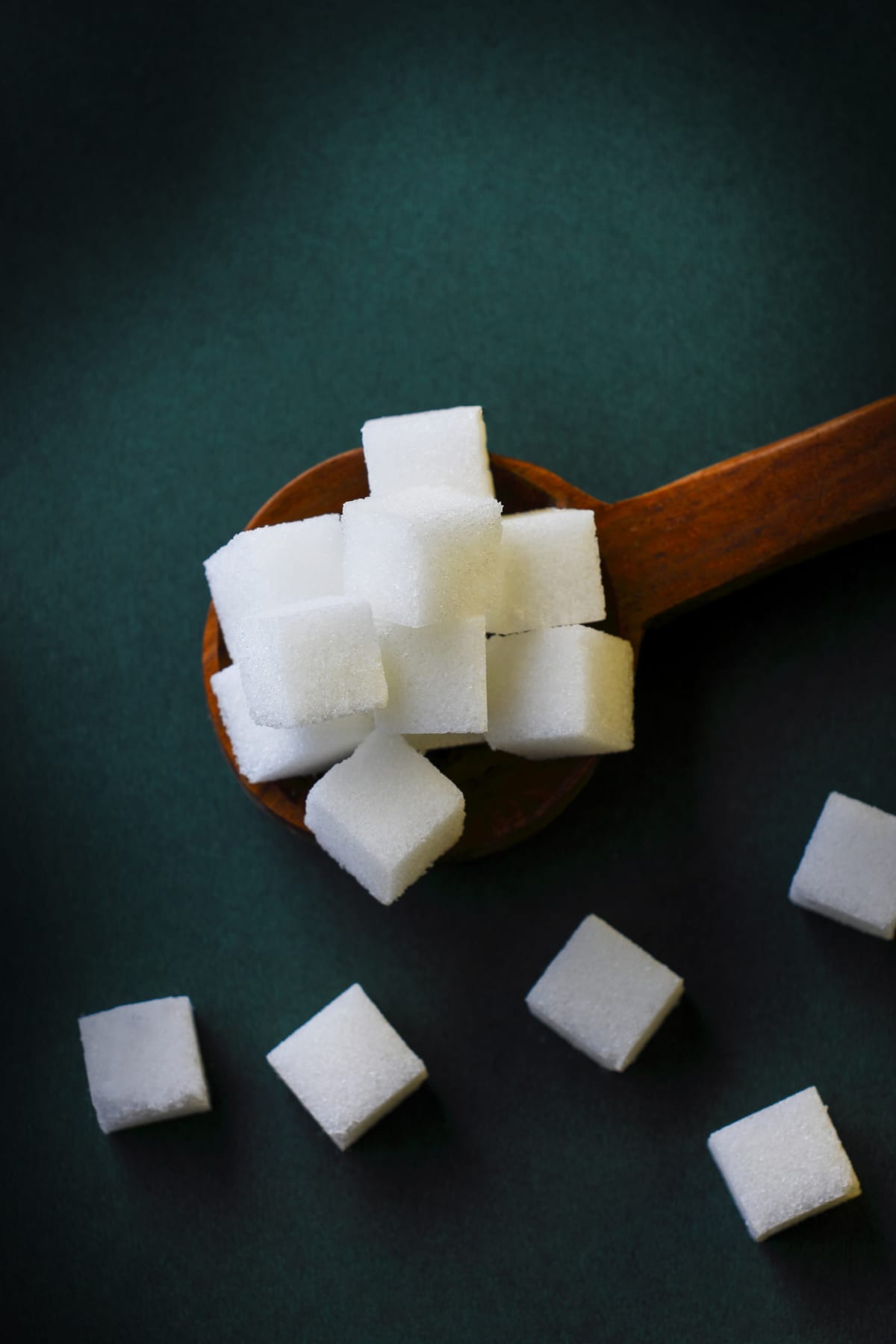 Sugar cubes in a wooden spoon