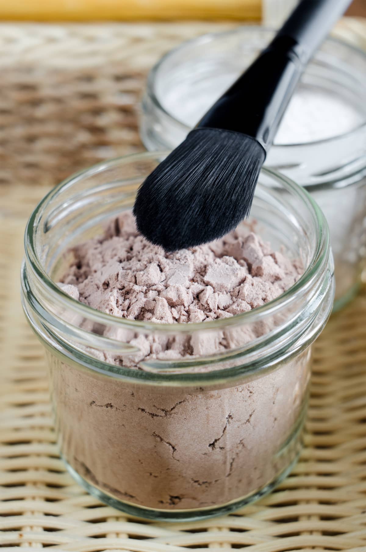 Mineral homemade powder foundation or dry shampoo in a grass jar. DIY cosmetics. Close up, copy space.