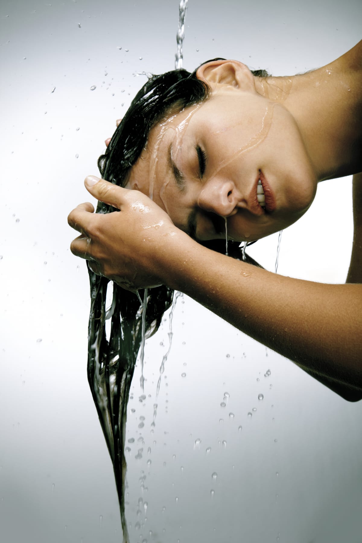 Woman washing her hair with her head flipped down