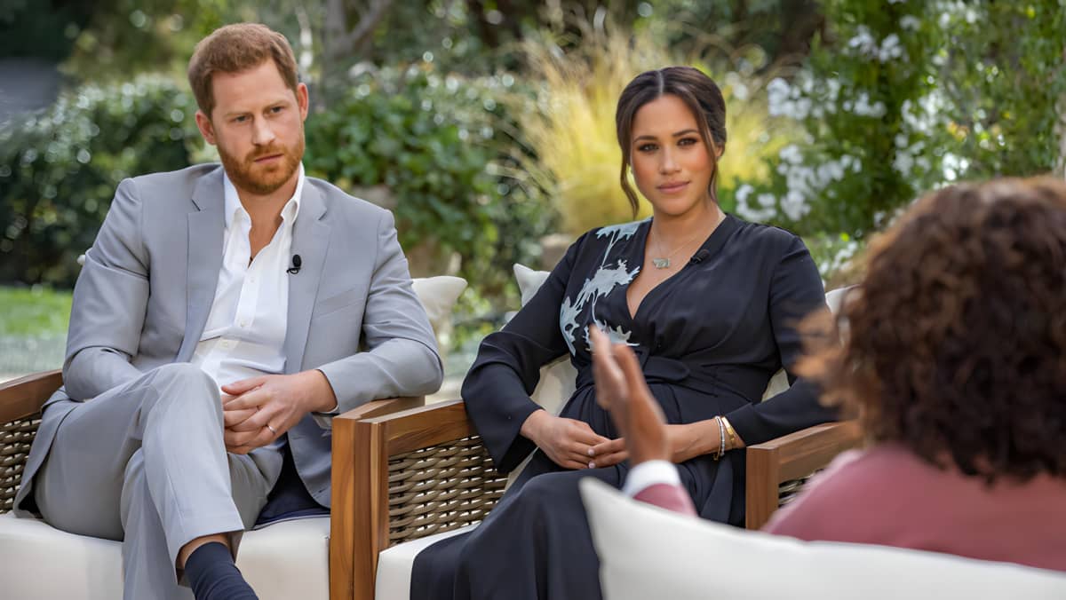 Megan Markle sitting with her hands in her lap