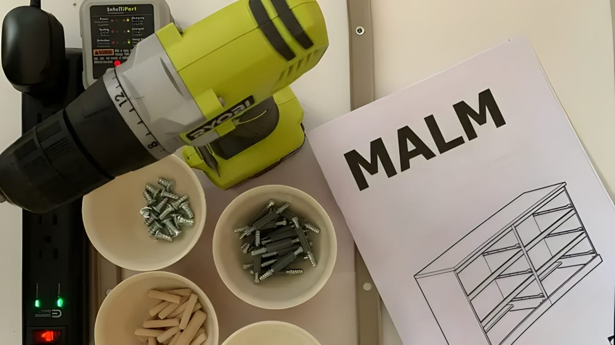 IKEA MALM instruction manual next to screws and a drill