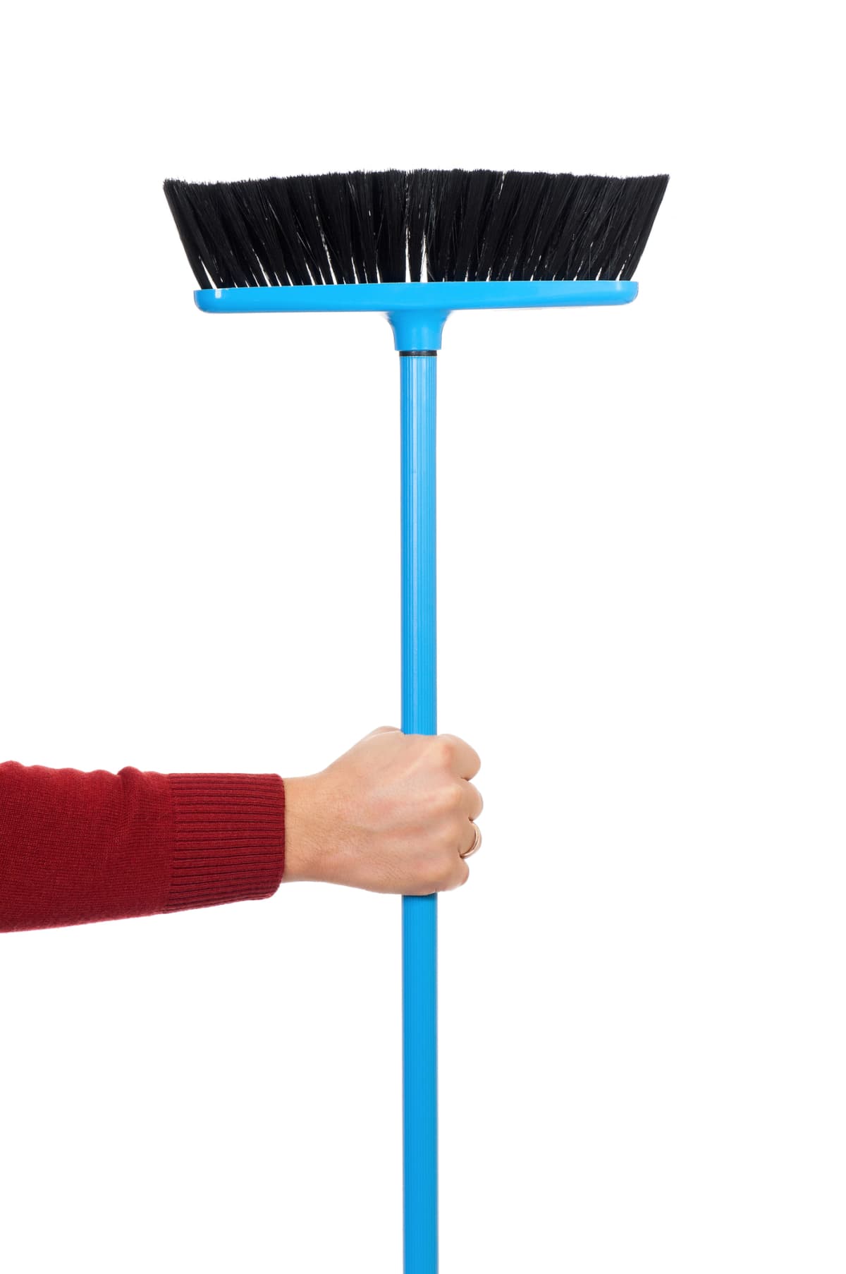 A person holding a plastic broom
