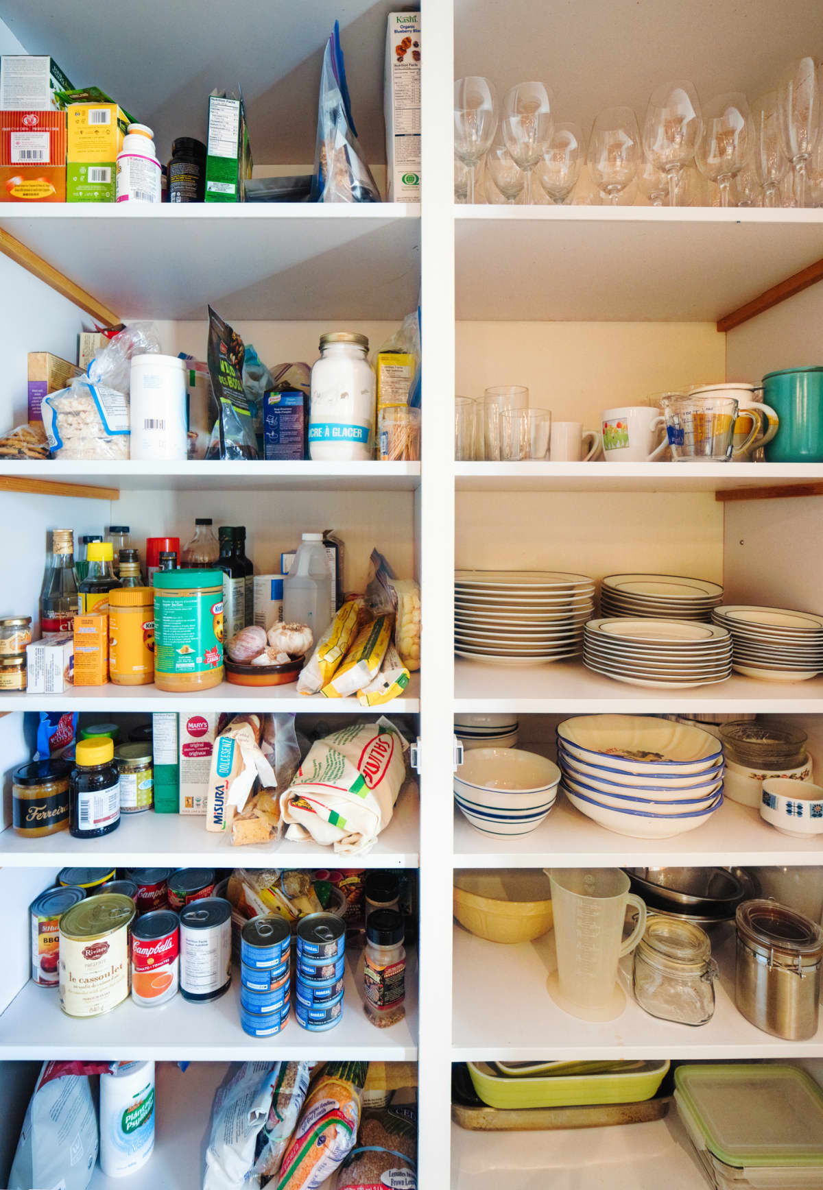 A kitchen pantry with open shelves.