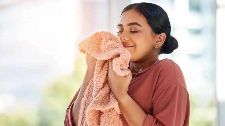A woman holding a fresh towel