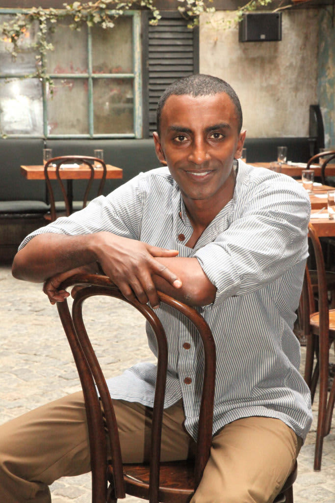 Portrait of Ethiopian-born Swedish chef Marcus Samuelsson in the atrium dining room of his Harlem restaurant, Red Rooster, New York, New York, 2010. (Photo by Anthony Barboza/Getty Images)