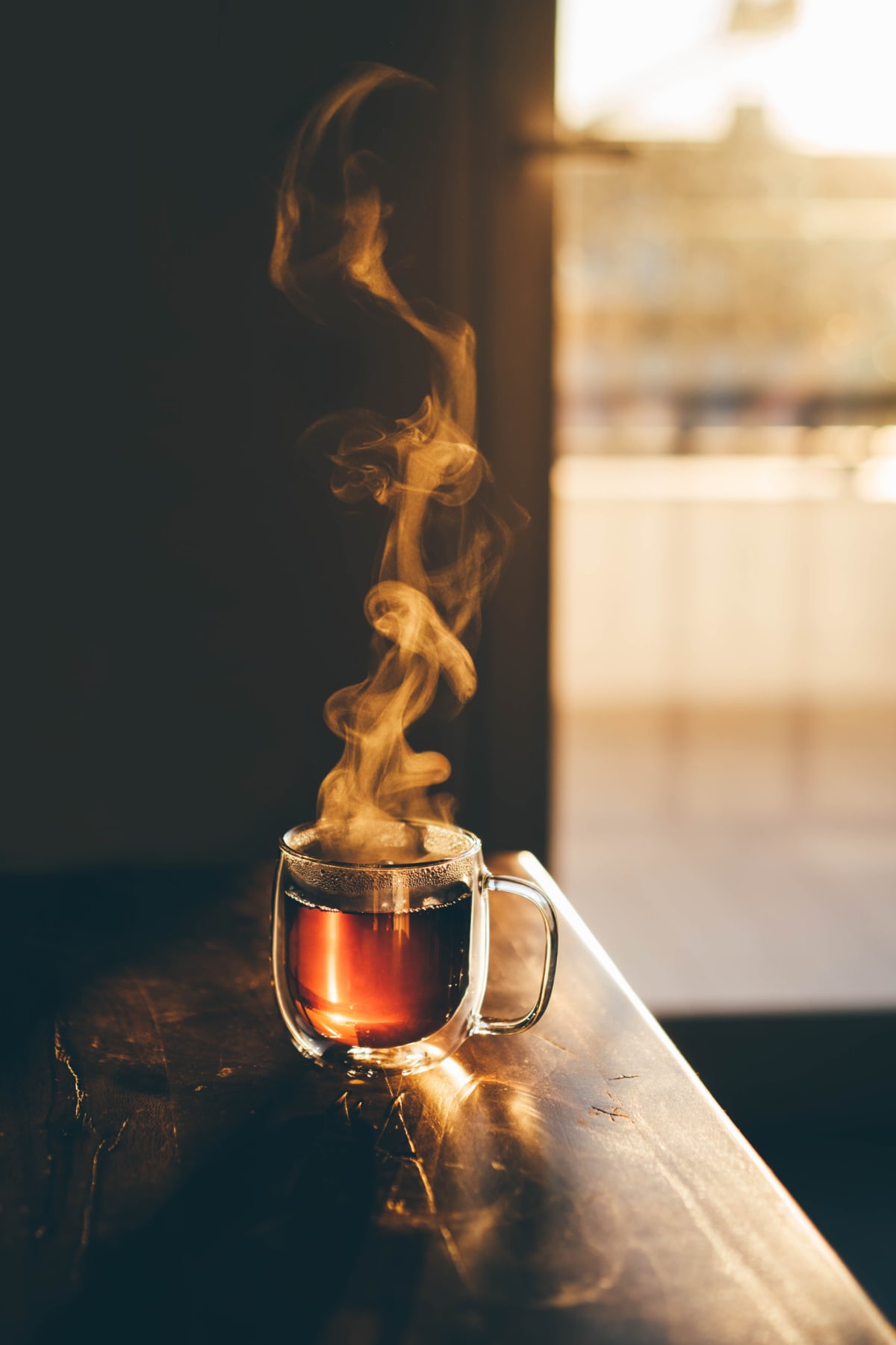 Steaming cup of tea on table