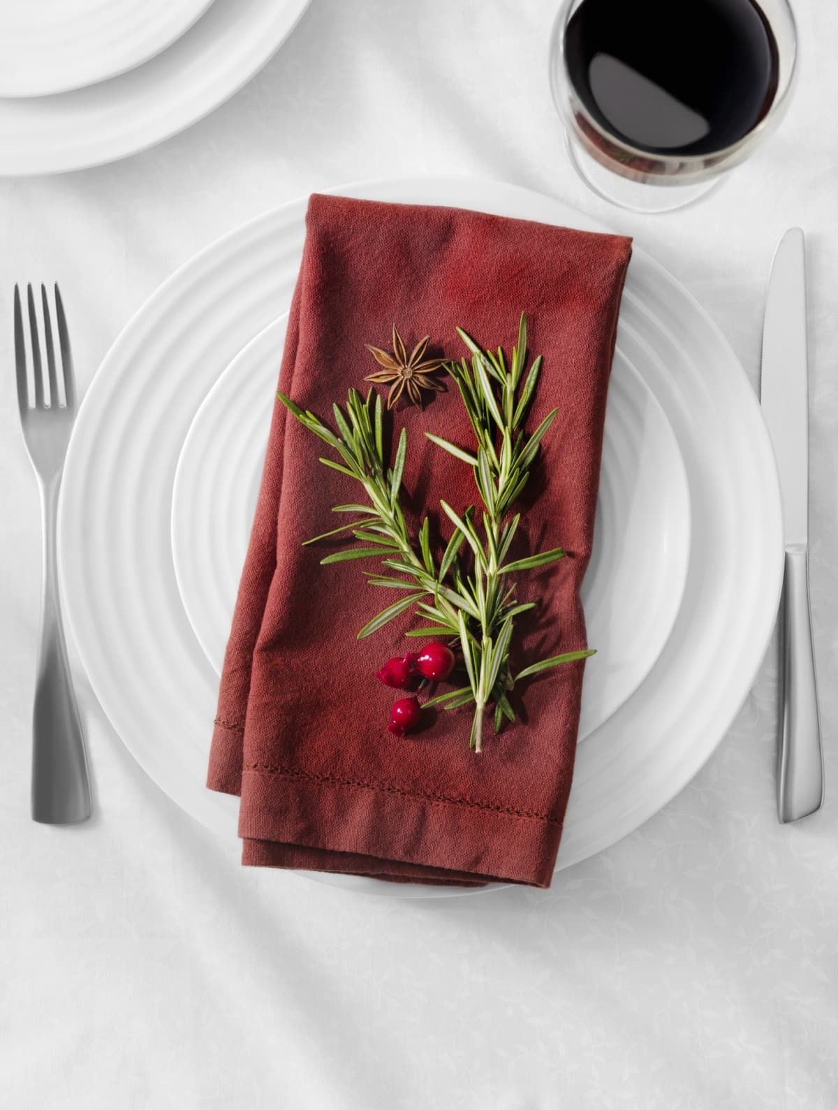 Napkin placed on a plate on a table.