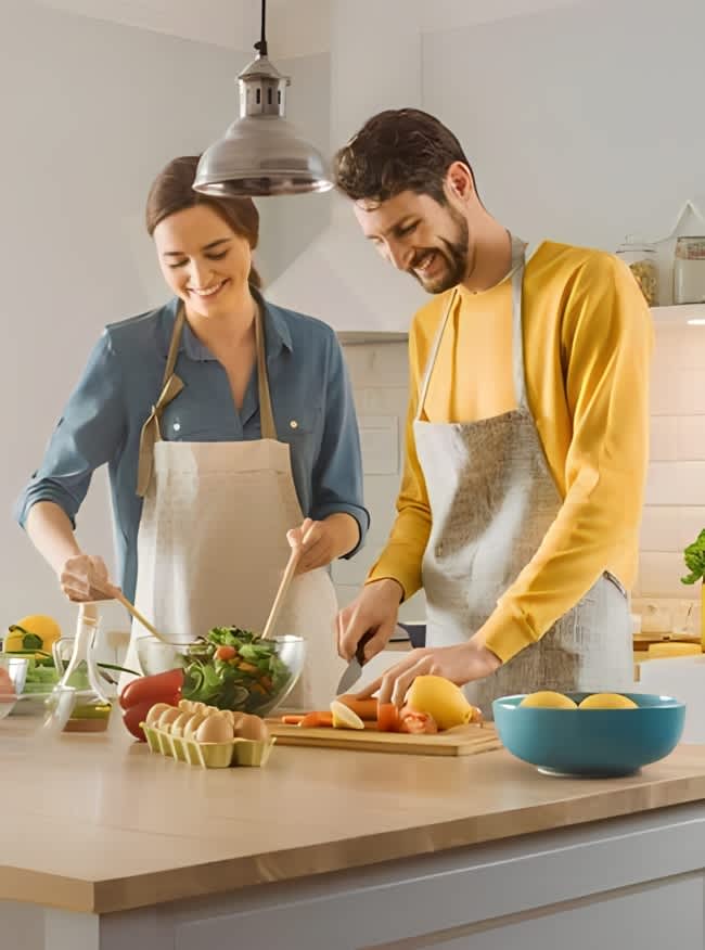 Couple preparing food with a variety of ingredients