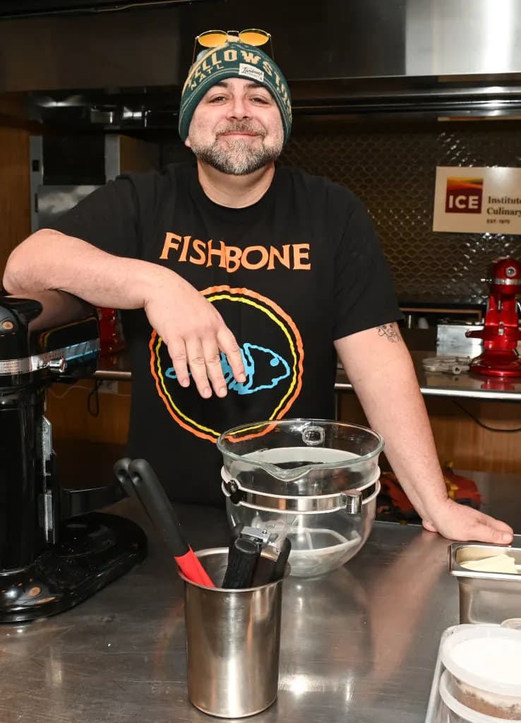Duff Goldman smiling in a kitchen