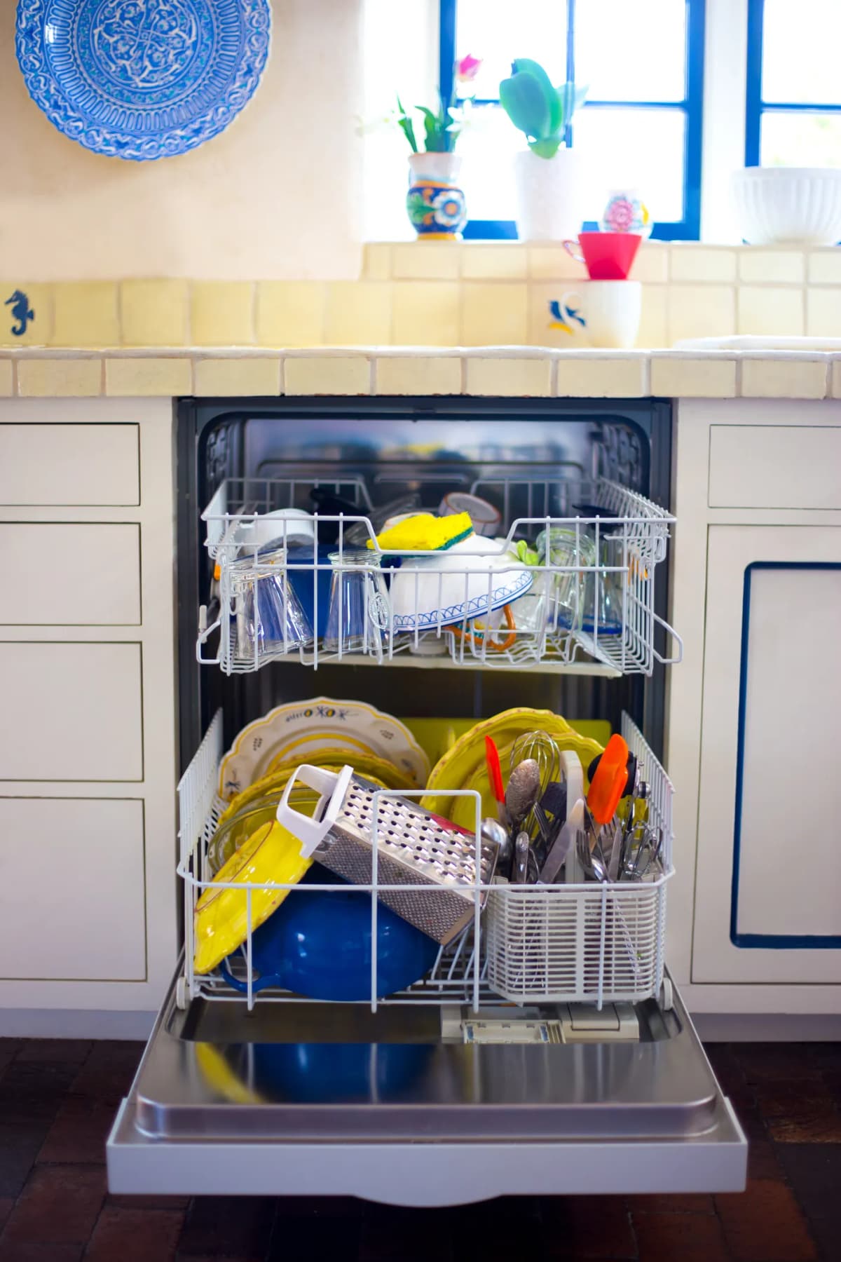 Open dishwasher with dishes inside
