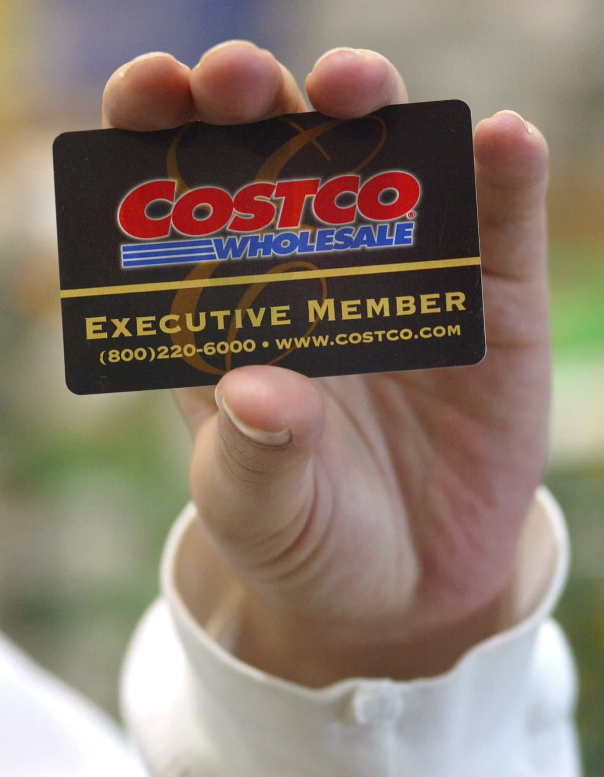 Hand holding a Costco membership card