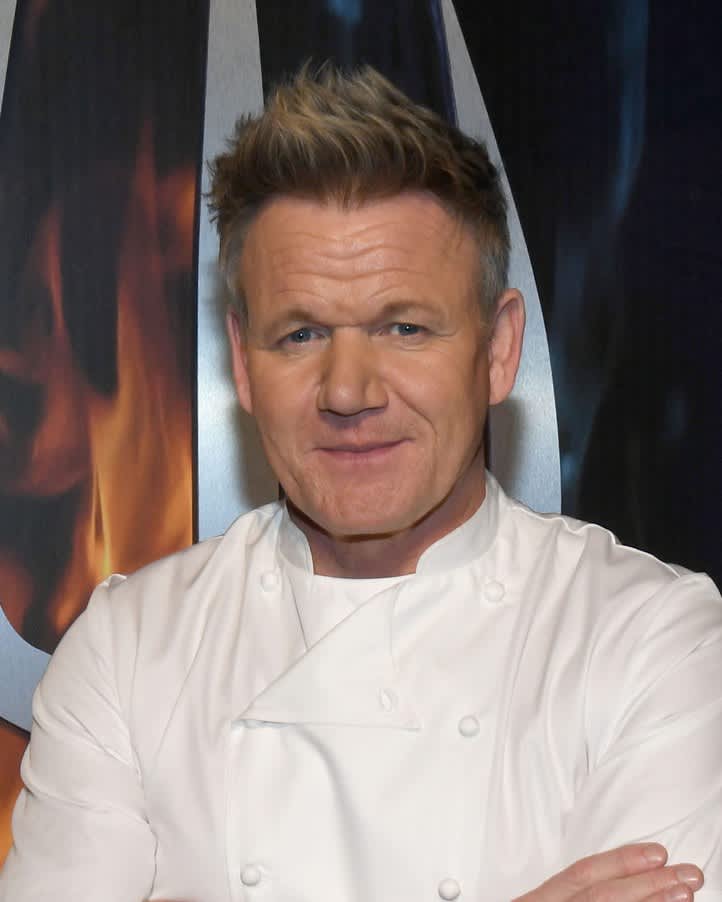 Gordon Ramsay with a chef's coat on smiling