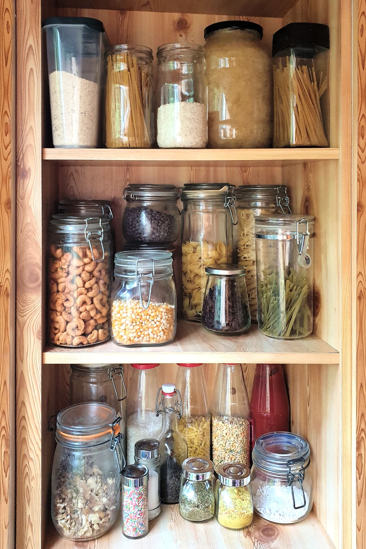 Glass jars of pantry staples on shelves