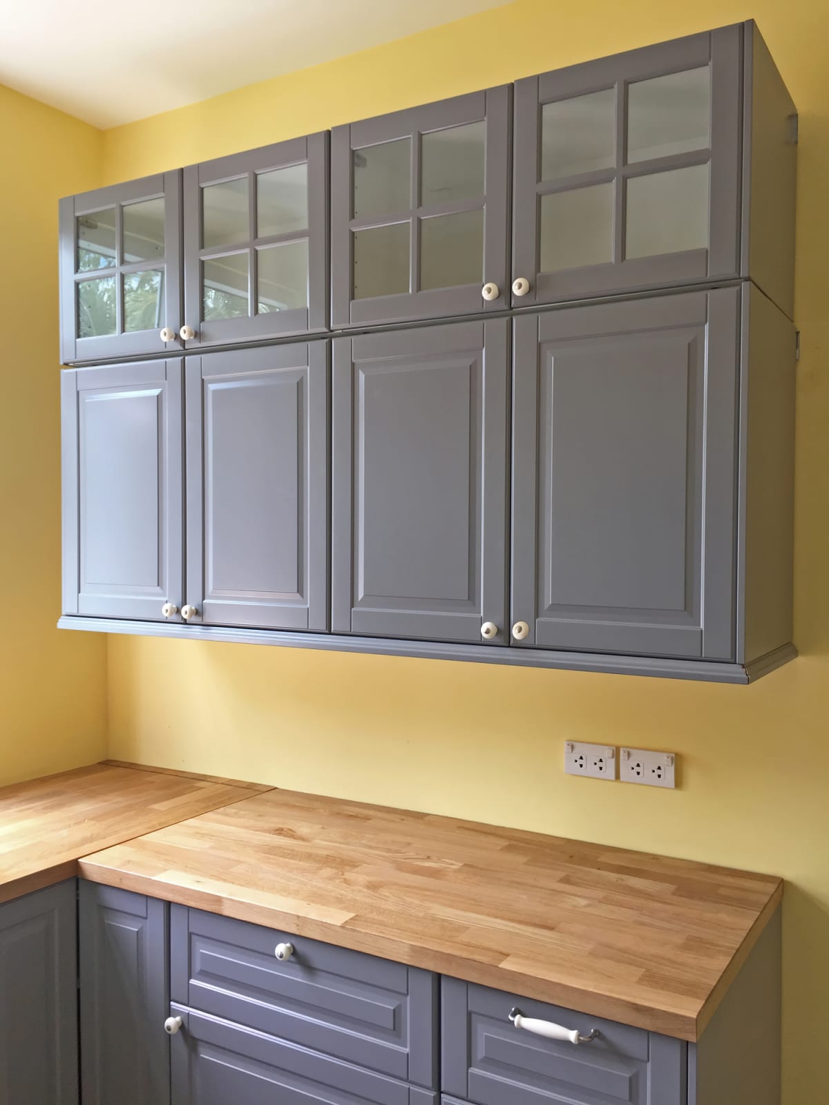 A kitchen with grey cabinets and drawers.