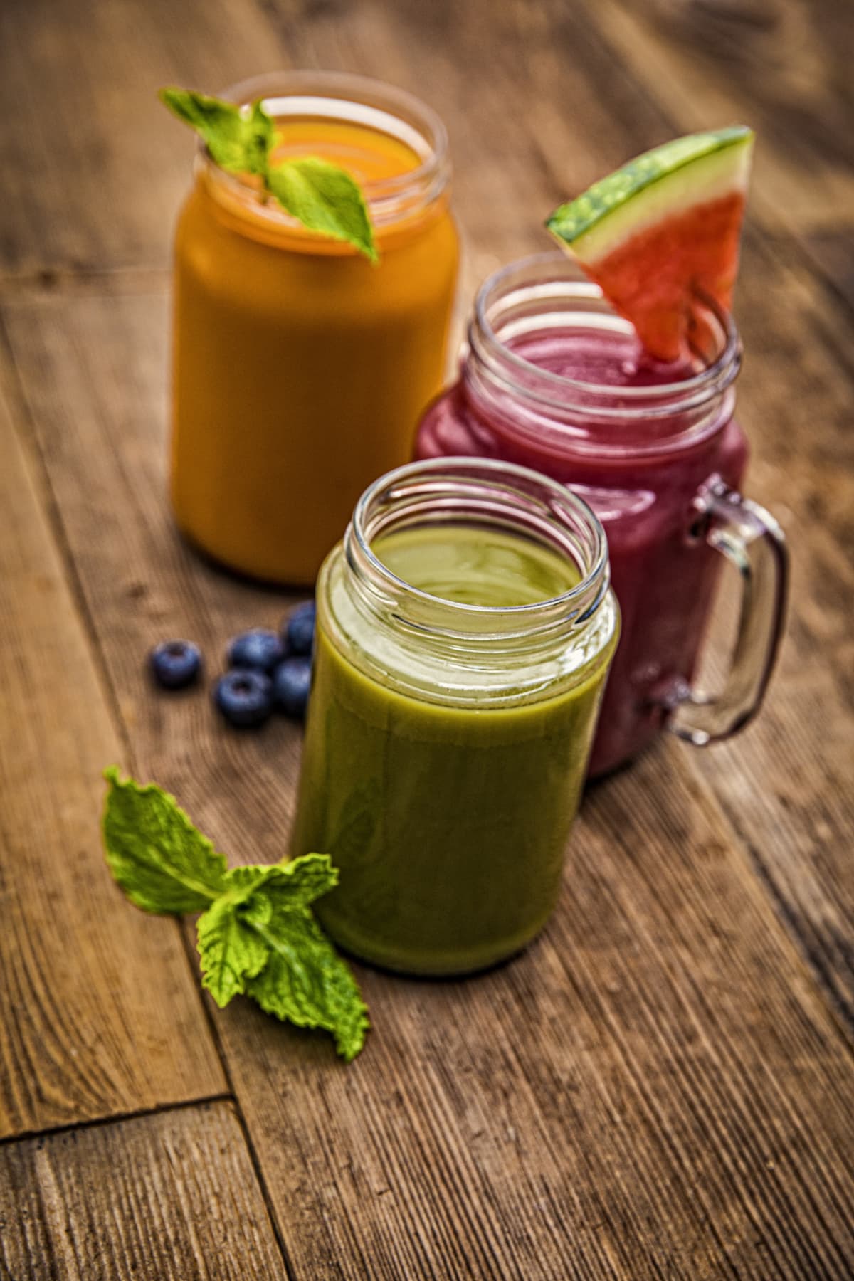 Three types of juice in glass jars