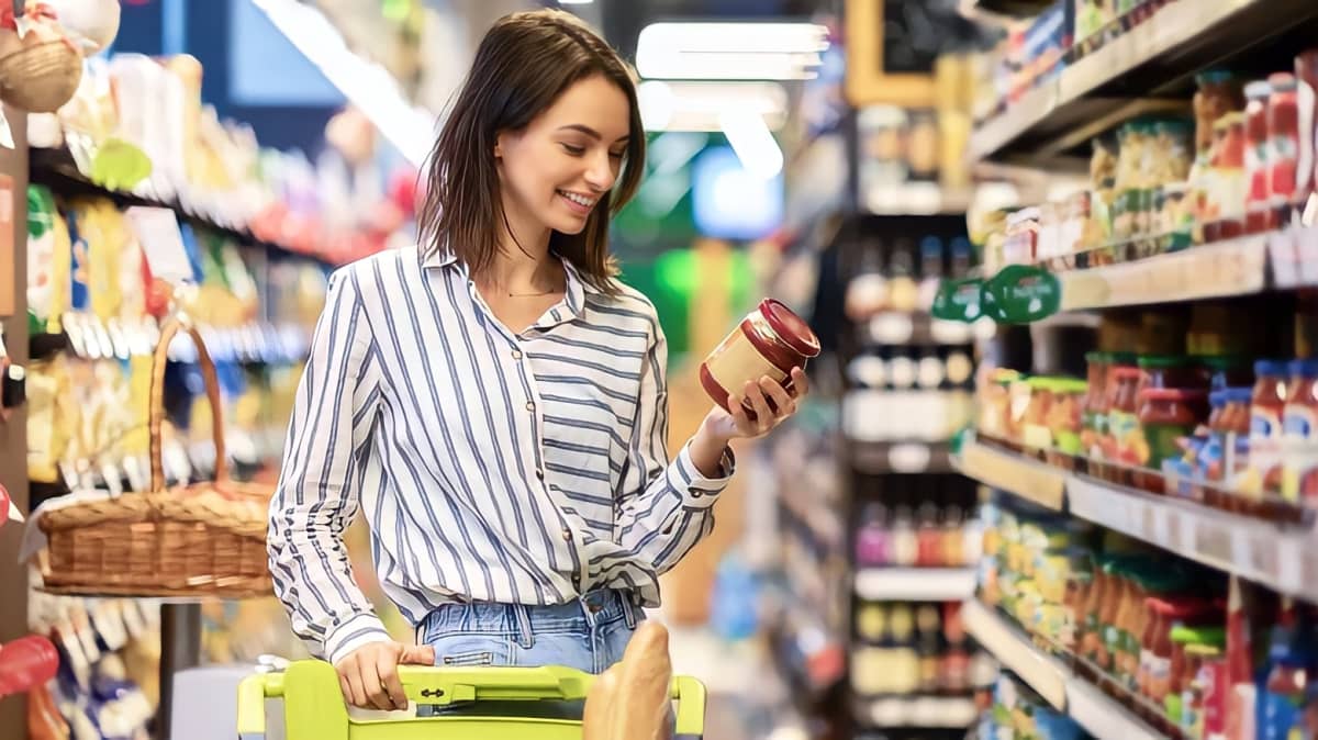Woman inspecting food label in grocery store