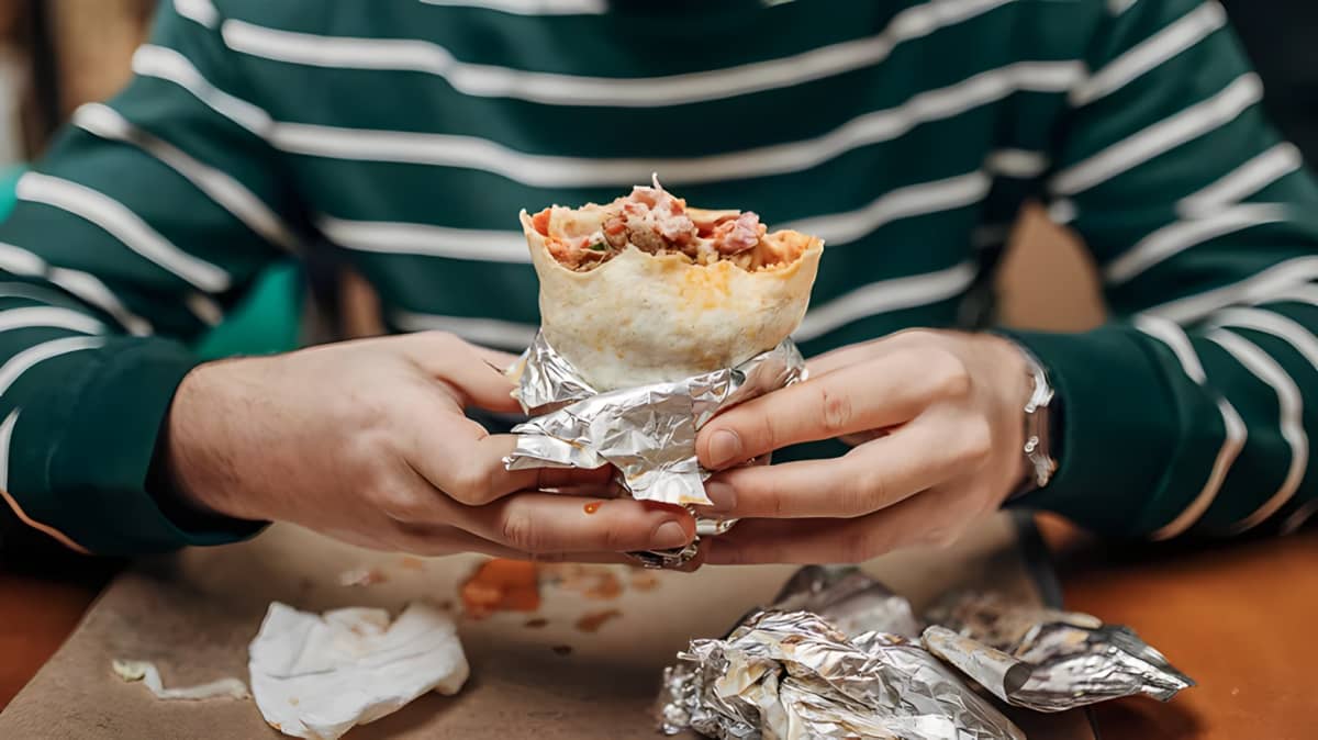 Hands holding a burrito