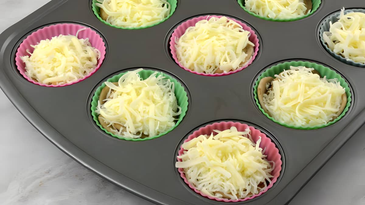 Cheese and potatoes in a muffin tin.