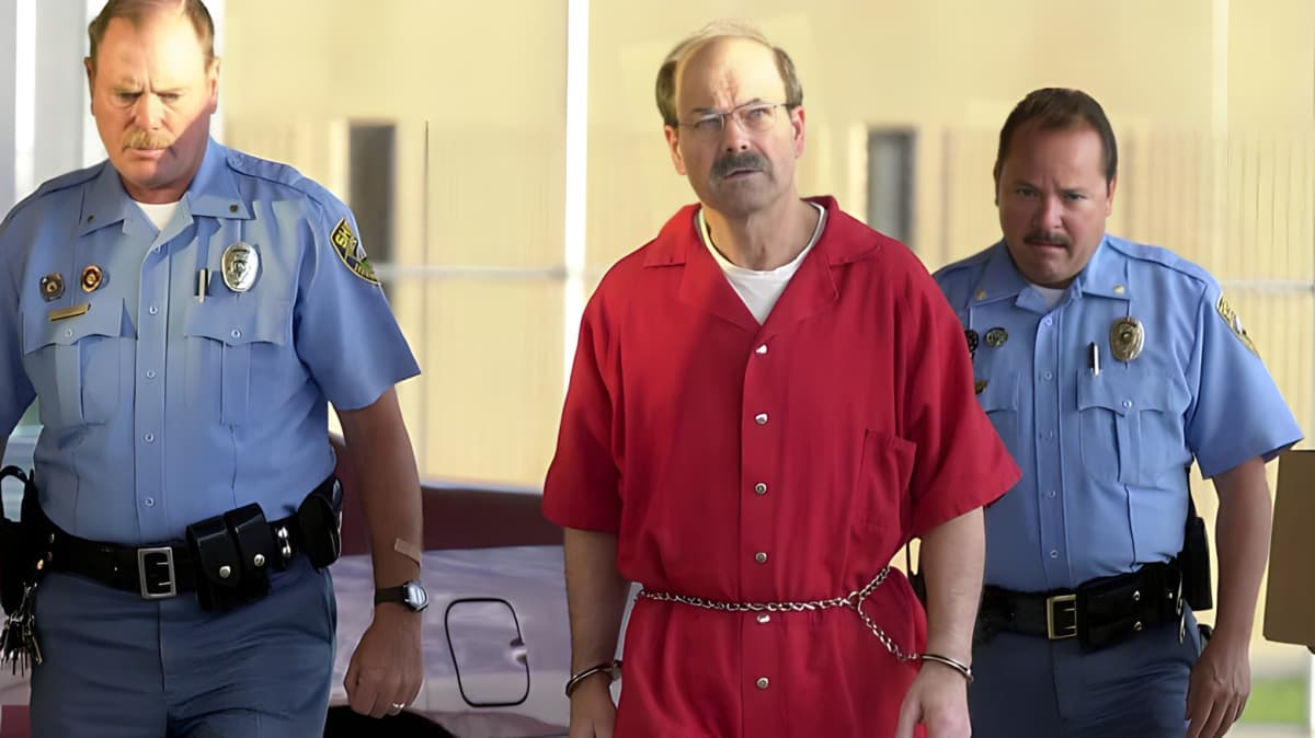 Correction officers walking with Dennis Rader