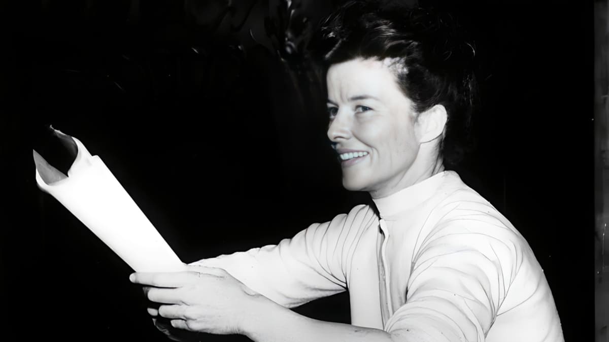 Katharine Hepburn smiling and holding a script