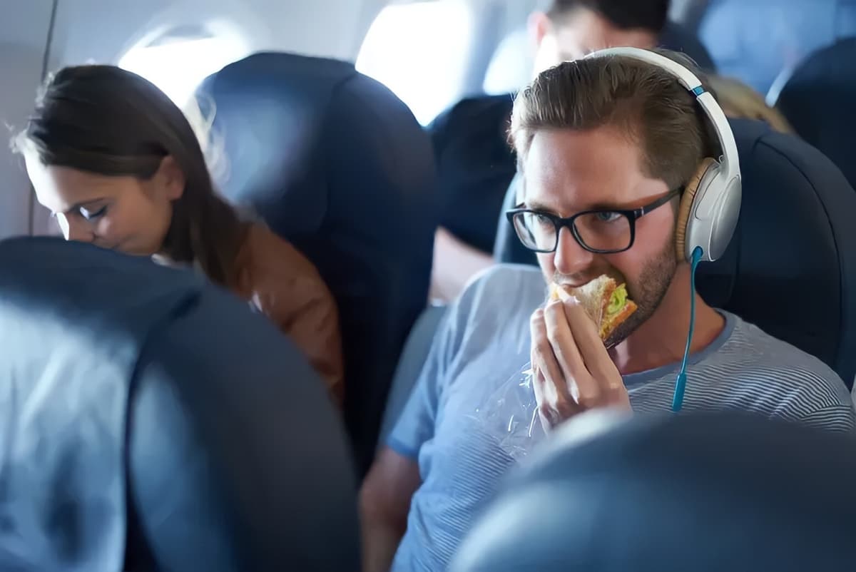 A passenger eating on a flight.