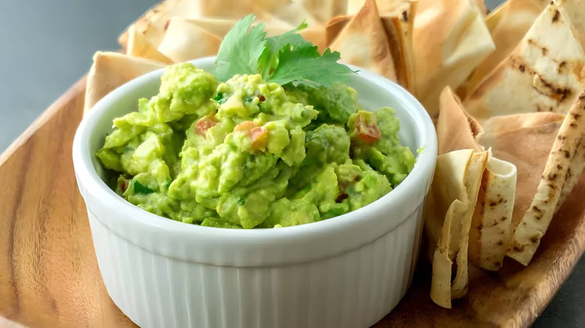 Guacamole and chips on a platter.
