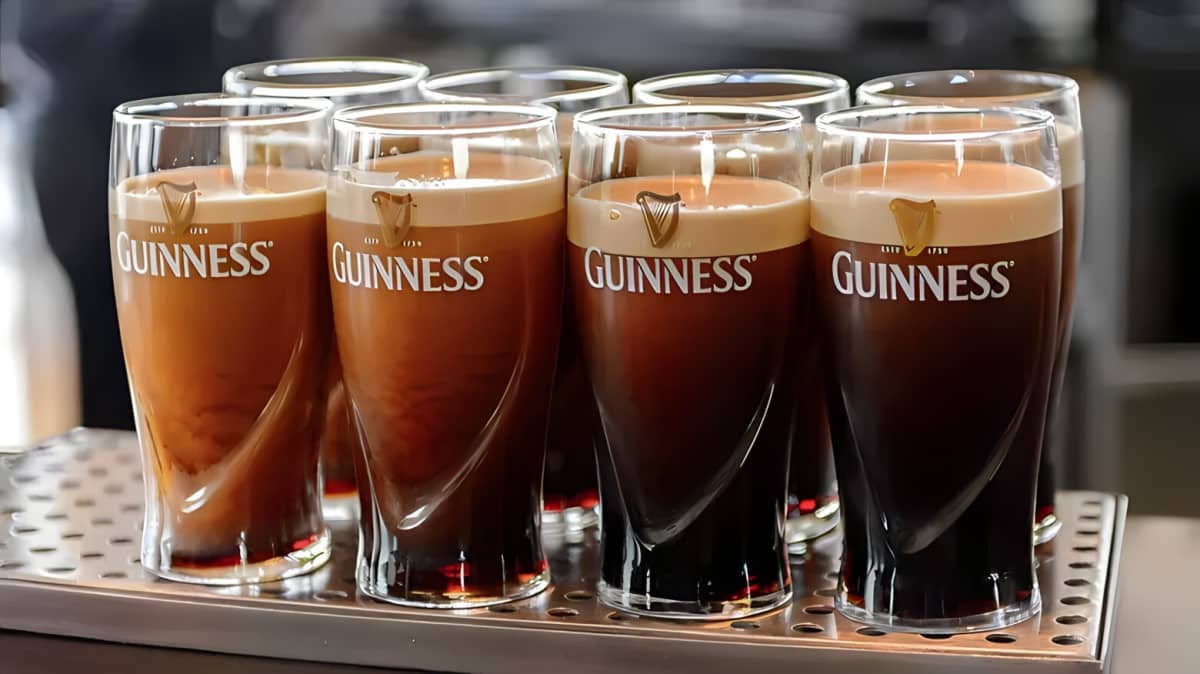 Eight glasses of Guinness on a bar top