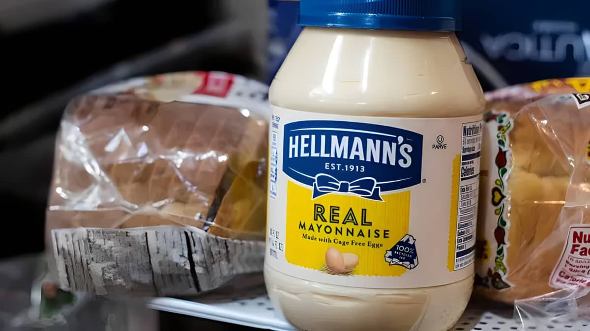 A jar of Hellmann's mayonnaise and bread.