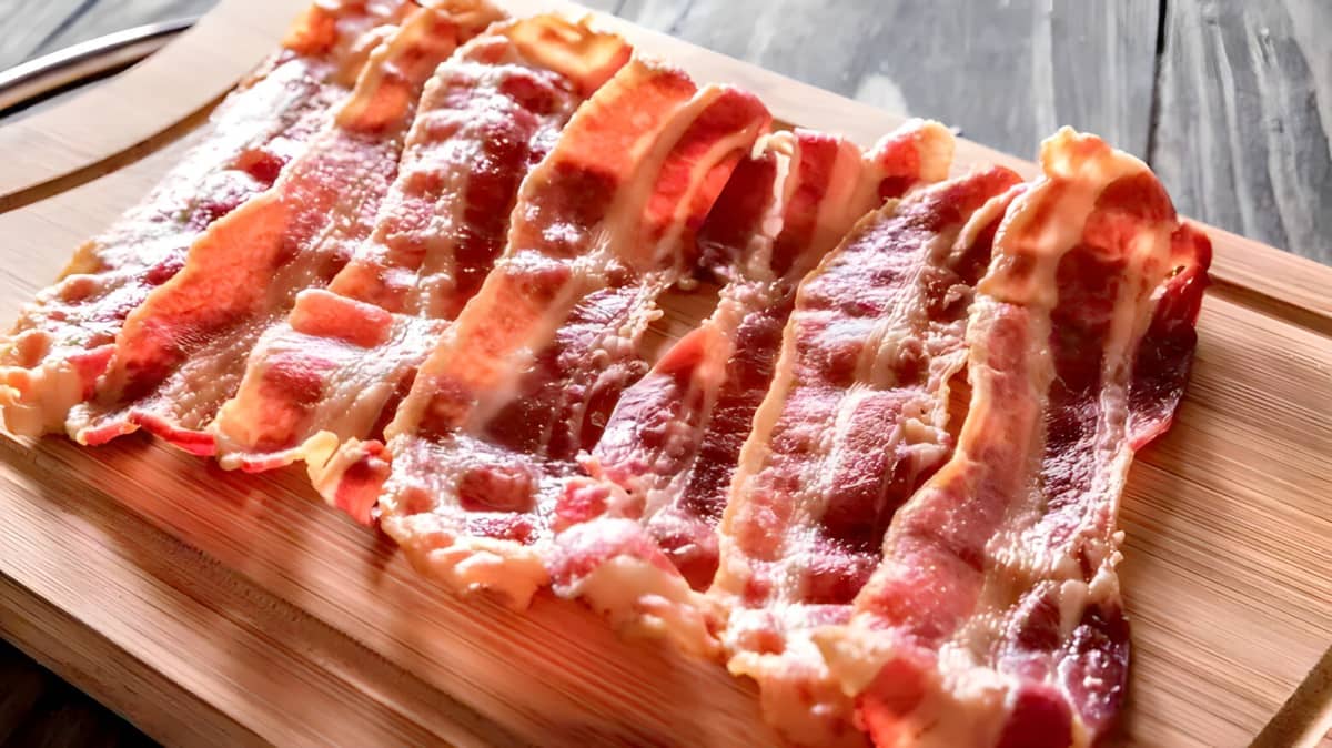 Cooked bacon on a board.