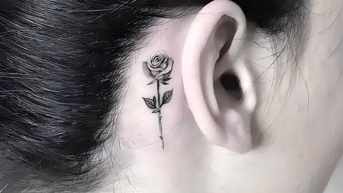 A rose tattooed behind an ear.