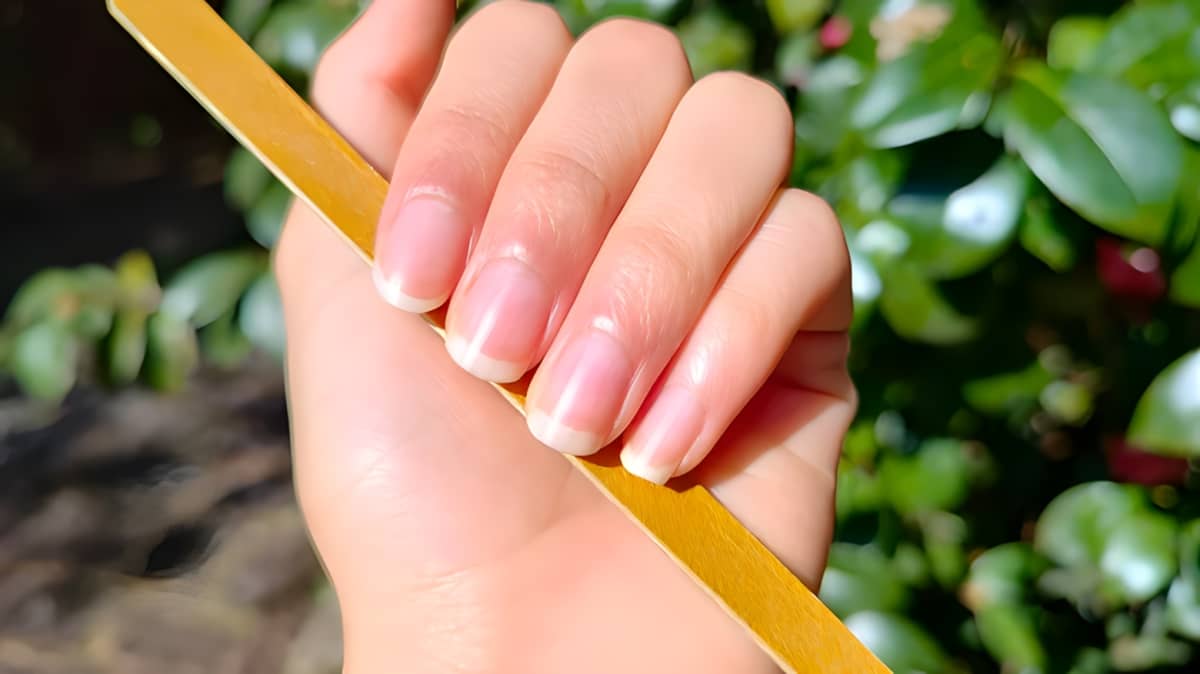 Clean nails holding a nail file