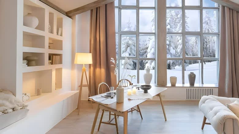 Large window with cosy interiour and snow outside